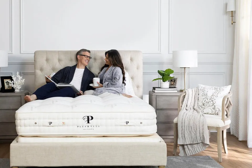 PlushBeds Royal Bliss luxury organic mattress with tufted top, styled in a bedroom